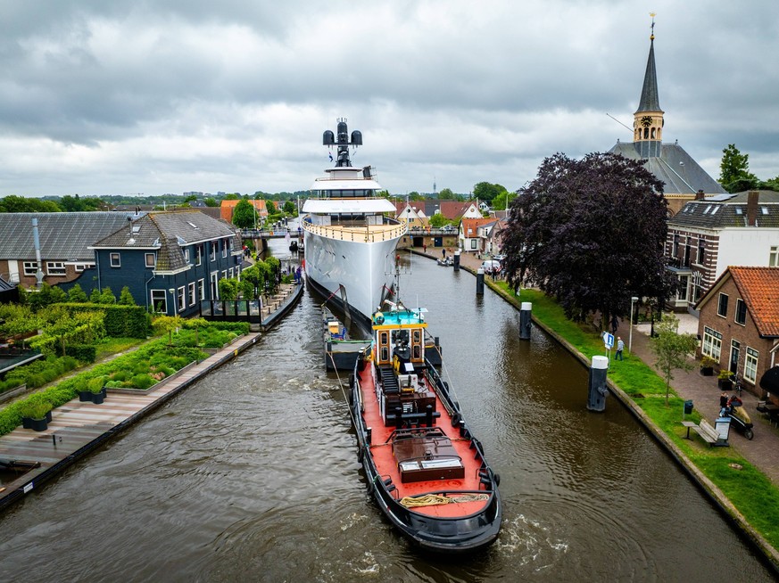 WOUBRUGGE - Passing and measuring at the Woubrugsebrug during the transport of former Starbucks CEO Howard Schultz s new yacht. The super deluxe mega yacht was built dooe Feadship and is 101.5 meters  ...