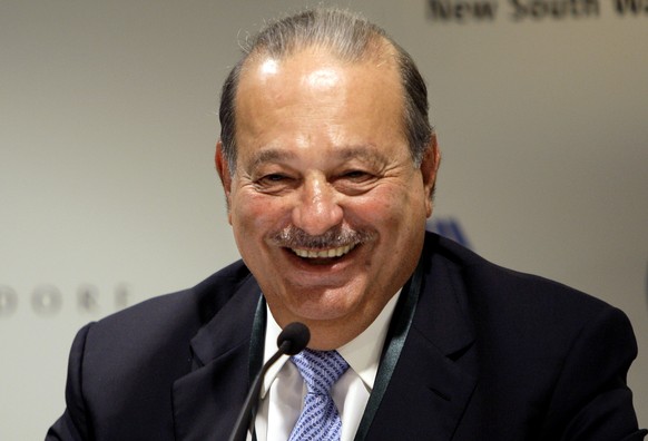 FILE - In this Wednesday, Sept. 29, 2010 file photo, Mexican tycoon Carlos Slim Helu holds a press conference at the Forbes Global CEO conference in Sydney. The eight individuals who own as much as ha ...