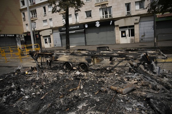 A charred vehicle is pictured Wednesday, June 28, 2023 in Nanterre, outside Paris. France&#039;s government announced heightened police presence around Paris and other big cities and called for calm a ...