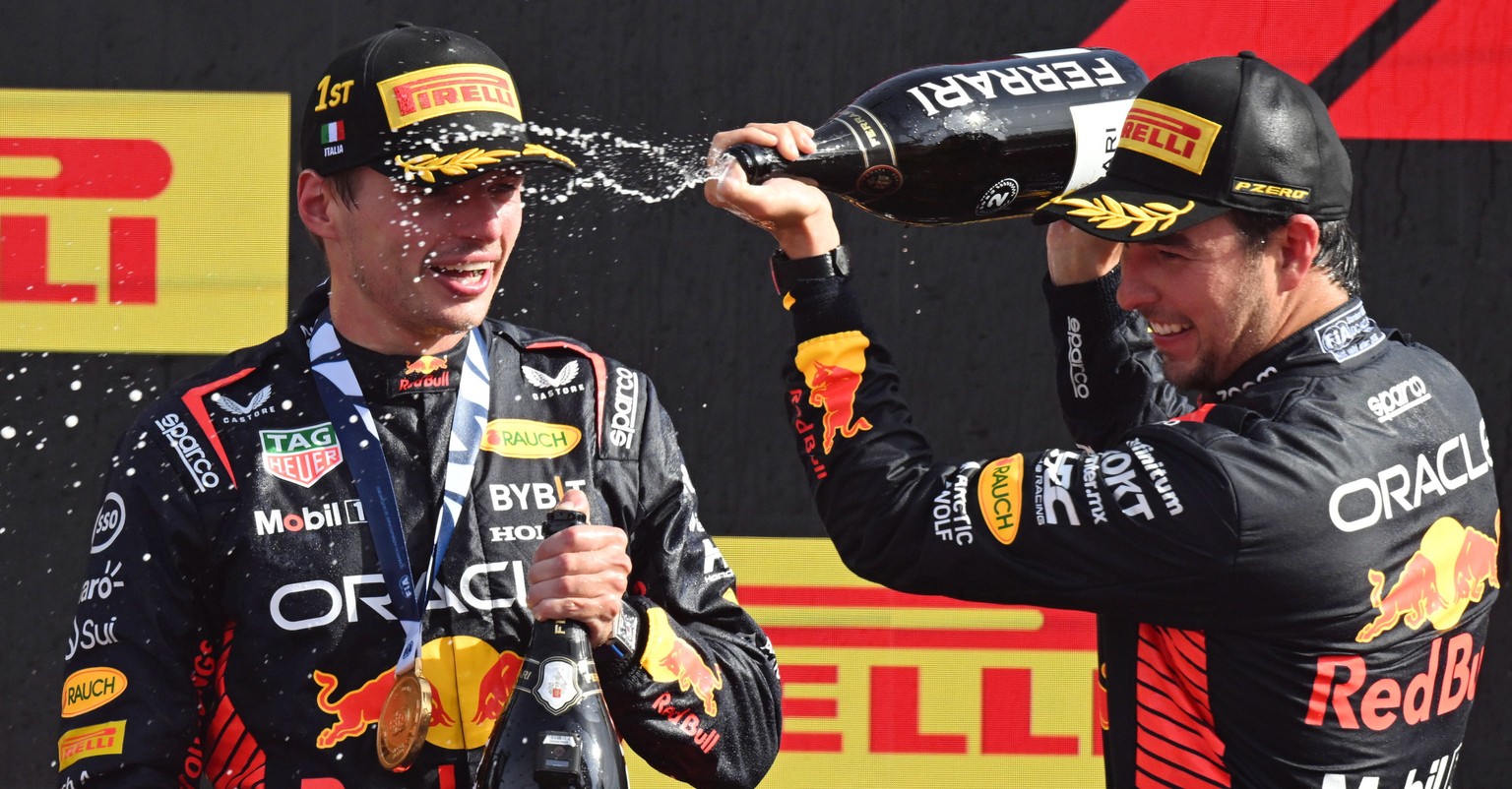 epa10838101 Winner Dutch driver Max Verstappen (L) of Red Bull Racing celebrates on the podium with second placed Mexican driver Sergio Perez of Red Bull Racing after the Italian Formula One Grand Pri ...
