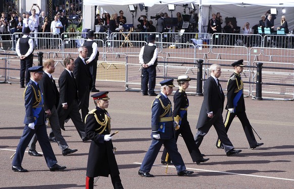 FILE - The media inside tents can be seen in background as Britain&#039;s King Charles III, Princess Anne, Prince Andrew, Prince Edward, Prince William, Prince Harry and Peter Phillips follow the coff ...