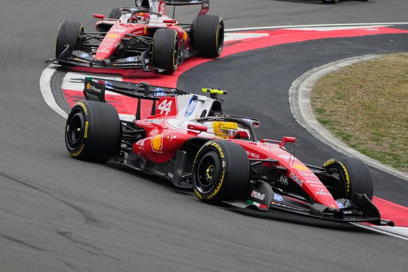 Ferrari driver Lewis Hamilton of Britain steers his car ahead of teammate Charles Leclerc of Monaco during the Chinese Formula One Grand Prix race at the Shanghai International Circuit, in Shanghai, C ...