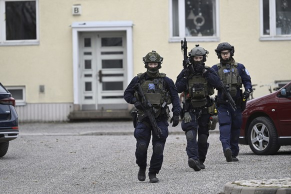 Police officers at the scene of Viertola comprehensive school, in Vantaa, Finland, Tuesday, April 2, 2024. Finnish police say a number of people were wounded in a shooting at a school outside Helsinki ...