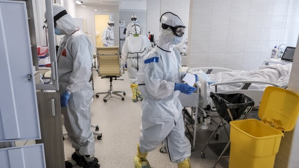 In this photo taken on Saturday, May 2, 2020, doctors work inside the intensive care unit for people infected with the new coronavirus, at a hospital in Moscow, Russia. A Russian epidemiologist says t ...