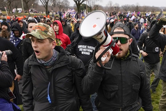 FILE - Proud Boys members Zachary Rehl, left, and Ethan Nordean, left, walk toward the U.S. Capitol in Washington, in support of President Donald Trump, Jan. 6, 2021. An upcoming hearing of the U.S. H ...