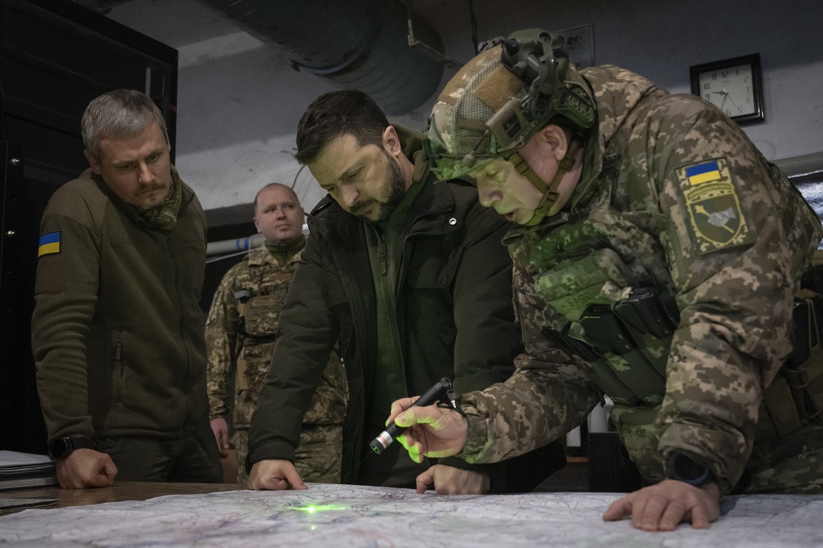 Ukrainian President Volodymyr Zelenskyy, Commander of Ukraine's Ground Forces Col.-Gen. Oleksandr Syrsky, right, and Roman Mashovets, deputy head of the Presidential Office, look at a map during  ...