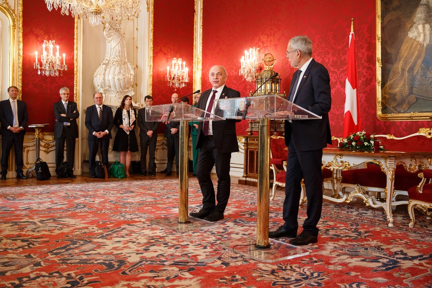 epa07275047 Swiss Federal President Ueli Maurer (L) and Austrian Federal President Alexander Van der Bellen (R) speak during a press conference after their meeting at the presidential office of the Ho ...