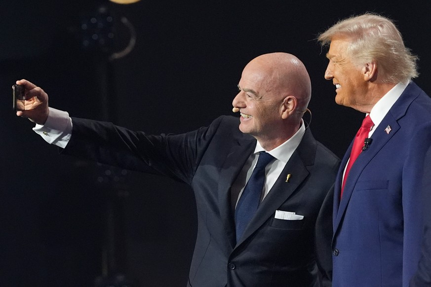 President Donald Trump and FIFA President Gianni Infantino take a selfie during the draw for the 2026 soccer World Cup at the Kennedy Center in Washington, Friday, Dec. 5, 2025. (AP Photo/Jacquelyn Ma ...