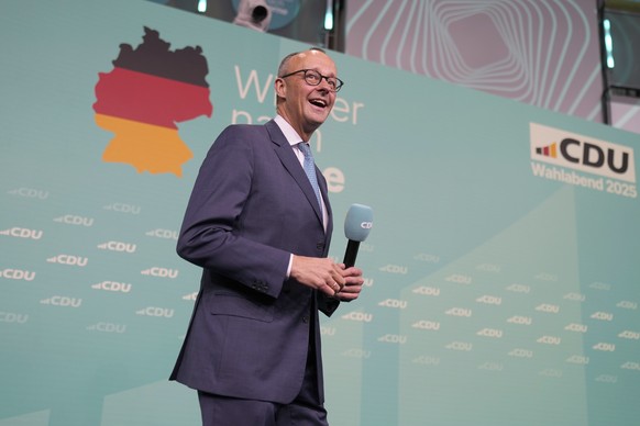 Friedrich Merz, the candidate of the mainstream conservative Christian Democratic Union party, arrives on stage to address supporters at the party headquarters in Berlin, Germany, Sunday, Feb. 23, 202 ...