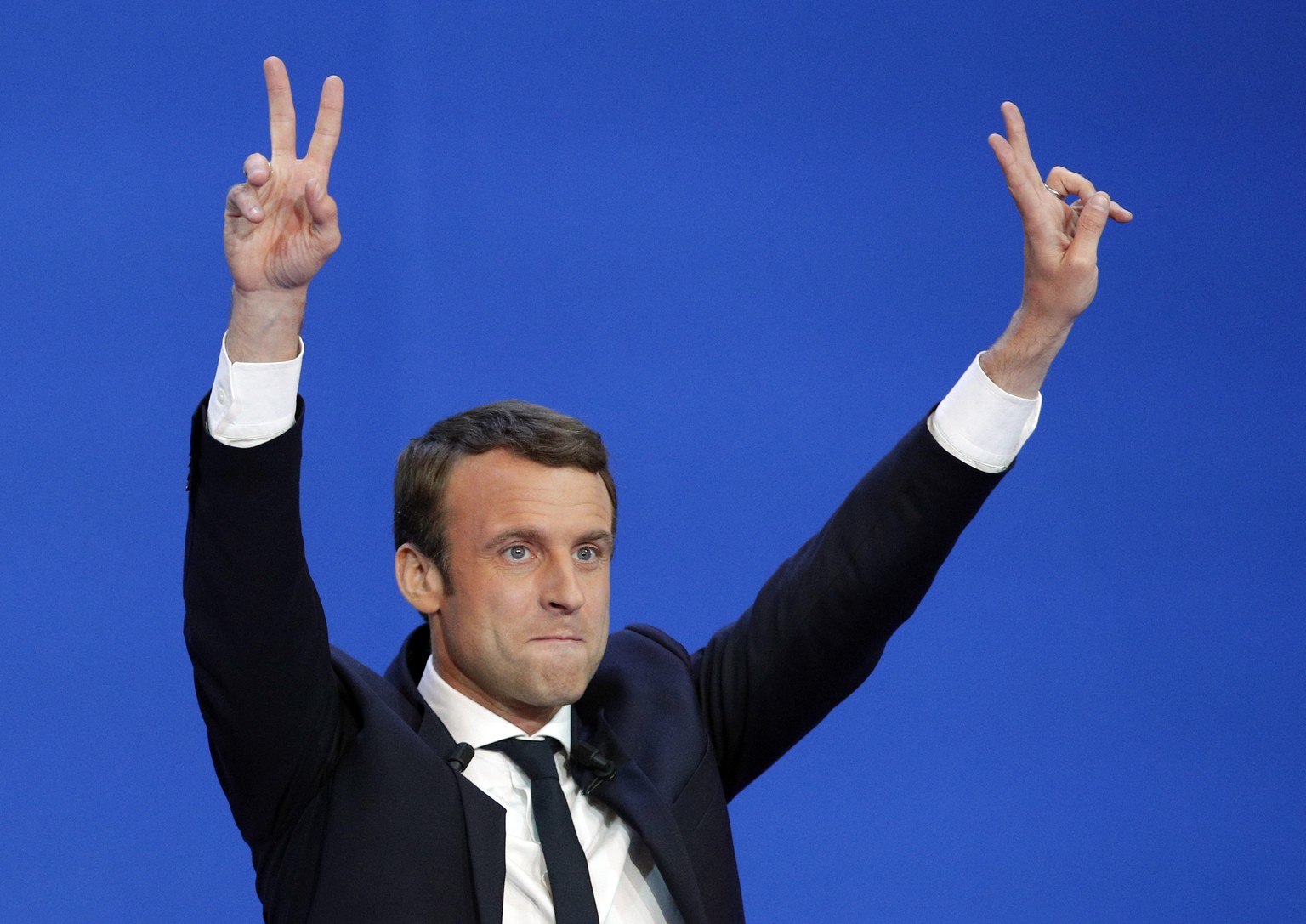 French centrist presidential candidate Emmanuel Macron waves before addressing his supporters at his election day headquarters in Paris , Sunday April 23, 2017. Macron and far-right populist Marine Le ...