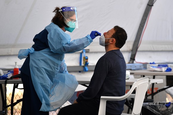 epa09304880 People are tested for COVID-19 at a pop-up clinic at Rushcutters Bay in Sydney, New South Wales, Australia, 27 June 2021. More than five million people in Greater Sydney and its surrounds  ...