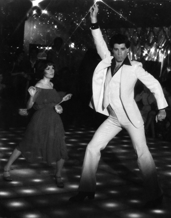 This is a photo of John Travolta and Karen Gorney dance in a nightclub scene to disco music in Paramount Pictures 1977 film "Saturday Night Fever", which explores the restless generation gro ...