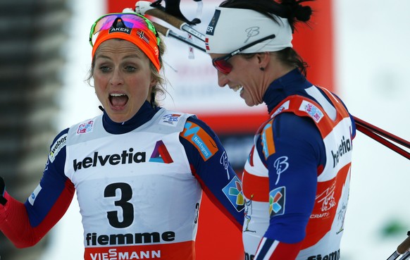 Norway's Therese Johaug and Marit Bjoergen react after a Tour de Ski, women's 10 km mass start classic event in Val di Fiemme, Italy, Saturday, ,Jan. 10 , 2014. (AP Photo/Alessandro Trovati)