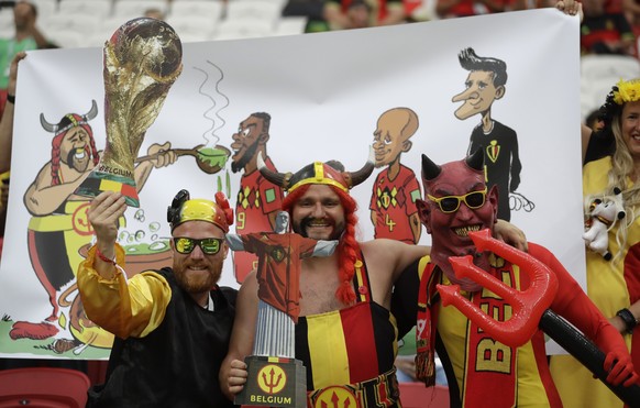 Belgian pose for the cameras in colourful costumes as they wait for the start of the quarterfinal match between Brazil and Belgium at the 2018 soccer World Cup in the Kazan Arena, in Kazan, Russia, Fr ...