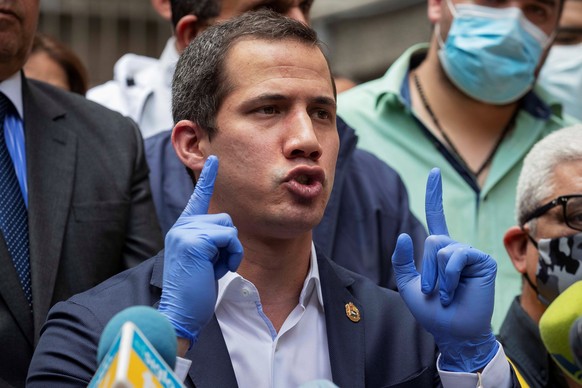 epa08491605 The President of the National Assembly of Venezuela, Juan Guaido (C), speaks during a joint press conference of the opposition at the headquarters of the Democratic Action (AD) party, in C ...