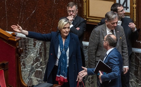 epa10522445 French member of Parliament for far-right Rassemblement National (RN) party Marine Le Pen (C) arrives at the weekly session of the questions to the government at the National Assembly in P ...