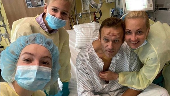 epa08670086 A undated, recent handout photo made available by Russian opposition leader Alexei Navalny via his Instagram site shows Navalny (2-R) at his Charite hospital bed where he is hospitalized i ...