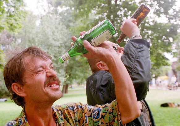 Two homeless men from a community gathering daily near the main railway station in Prague look through empty liquor and beer bottles as they watch solar eclipse in the Czech capital on Wednesday 11 Au ...