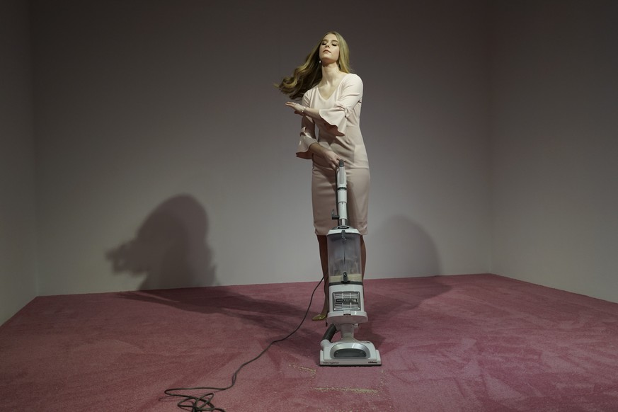 An Ivanka Trump lookalike vacuums crumbs thrown by spectators at Jennifer Rubell&#039;s art exhibit &quot;Ivanka Vacuuming 2019&quot; on Tuesday, Feb. 5, 2019, at Flashpoint Gallery in Washington. The ...