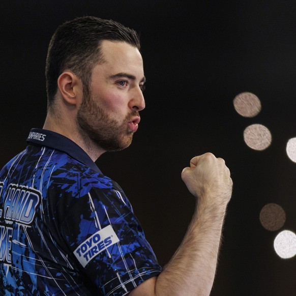 epa11054135 Luke Humphries of England reacts to winning against Scott Williams(not pictured) of England at the semi final match of the Paddy Power World Darts Championship at Alexandra Palace in Londo ...