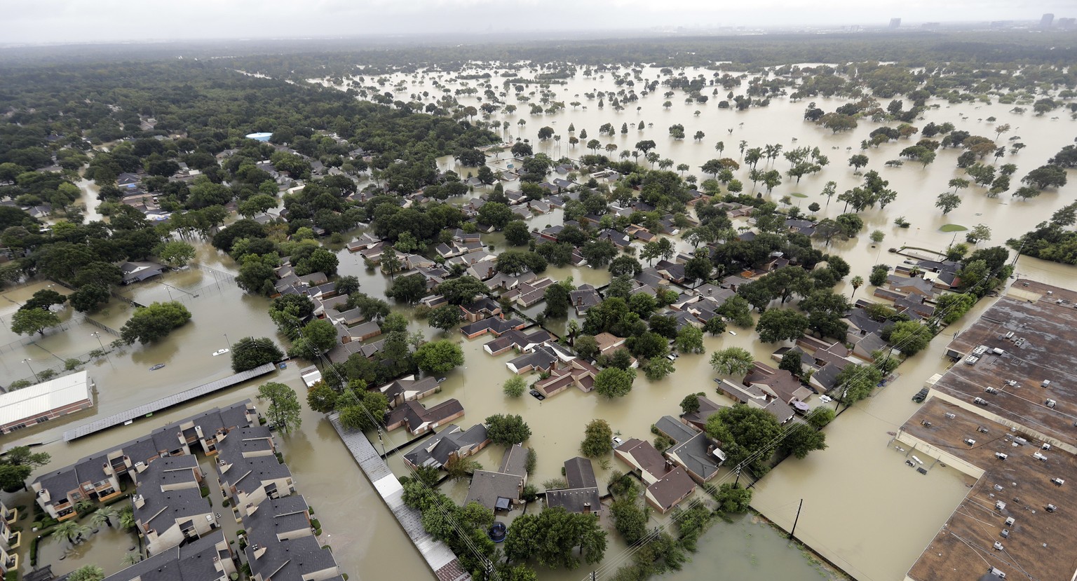In this aerial photo, a neighborhood near Addicks Reservoir are flooded by rain from Tropical Storm Harvey Tuesday, Aug. 29, 2017, in Houston. (AP Photo/David J. Phillip)