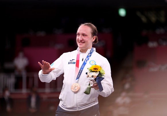 epa09404088 Bronze medalist Sofya Berultseva of Kazakhstan poses with her medal on the podium during the medal ceremony for women&#039;s kumite +61kg Karate events of the Tokyo 2020 Olympic Games at t ...