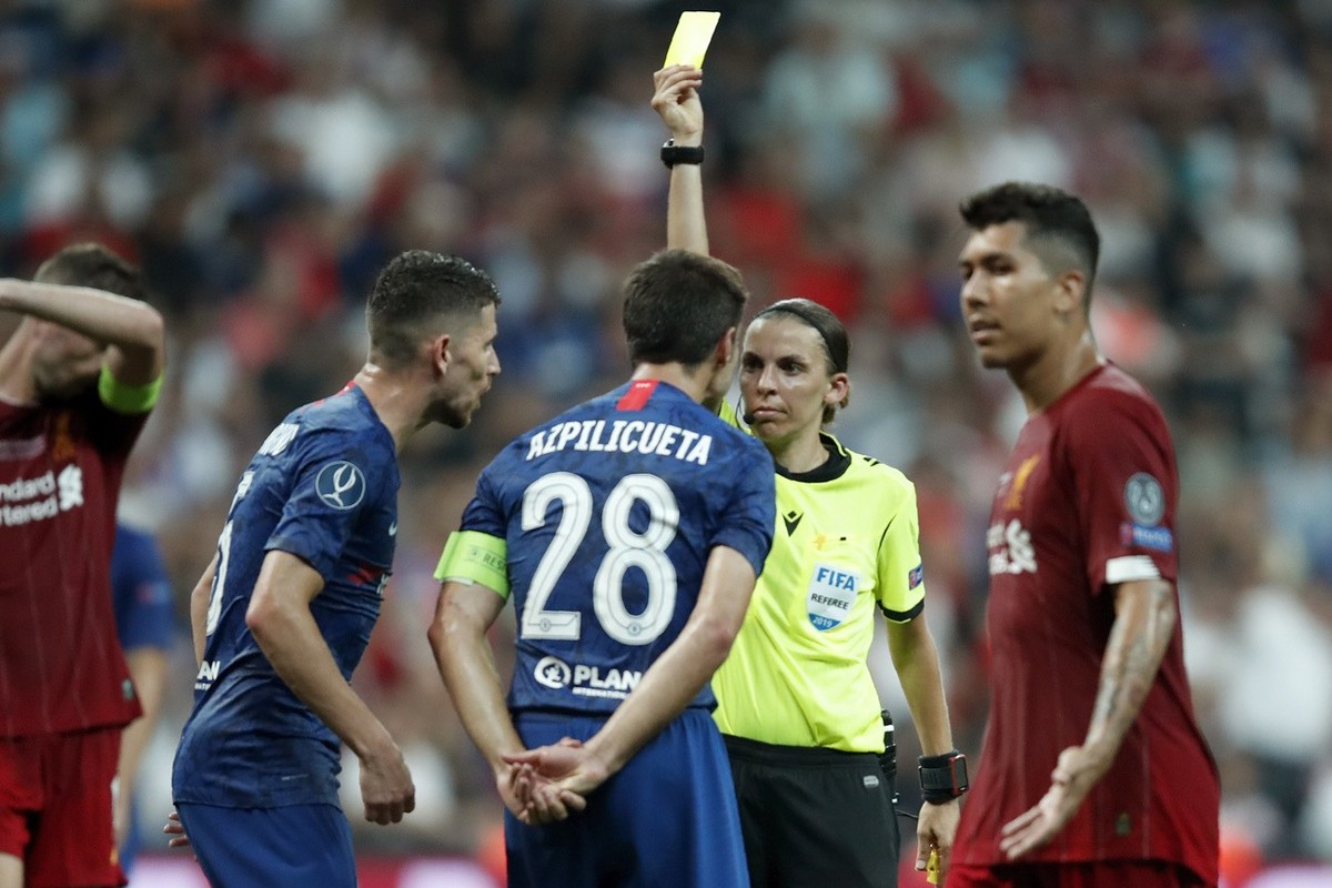 Referee Stephanie Frappart shows a yellow card to Chelsea's Cesar Azpilicueta during the UEFA Super Cup soccer match between Liverpool and Chelsea, in Besiktas Park, in Istanbul, Wednesday, Aug.  ...