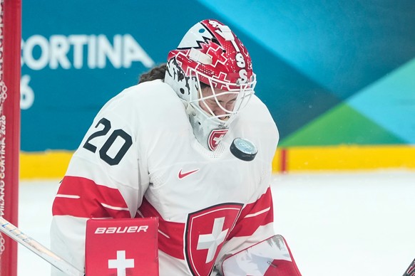Switzerland's Andrea Braendli deflects the puck shot by Canada's Emily Clark during a semifinal match of women's ice hockey between the Canada and Switzerland at the 2026 Winter Olympic ...
