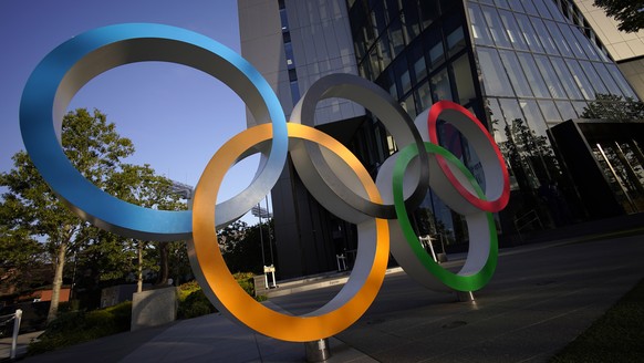 epa09154577 An Olympic Rings monument is displayed near the National Stadium, the main venue of the Tokyo 2020 Olympics and Paralympics, in Tokyo, Japan, 23 April 2021. Japanese Prime Minister Yoshihi ...