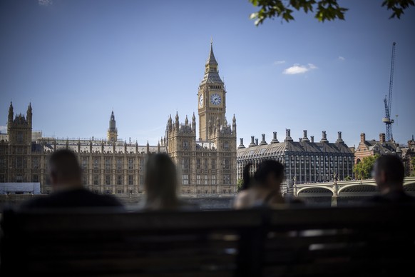 epa10059543 People walk along the Southbank with The Palace of Westminster, home to the Houses of Parliament, in the background in London, Britain, 08 July 2022. Senior Conservative members of parliam ...