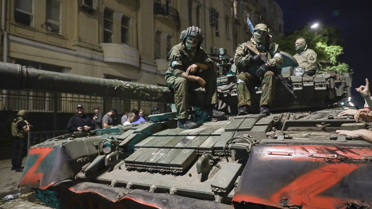 FILE - Membes of the Wagner Group military company sit atop of a tank on a street in Rostov-on-Don, Russia, Saturday, June 24, 2023, prior to leaving an area at the headquarters of the Southern Milita ...