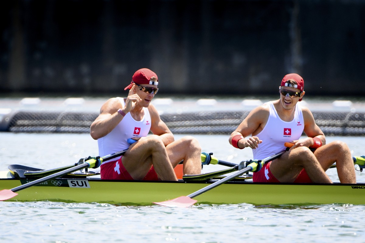 Swiss rowers Barnabe Delarze and Roman Roeoesli react after crossing the finish line in the men's rowing double sculls heat at the 2020 Tokyo Summer Olympics in Tokyo, Japan, on Friday, July 23,  ...