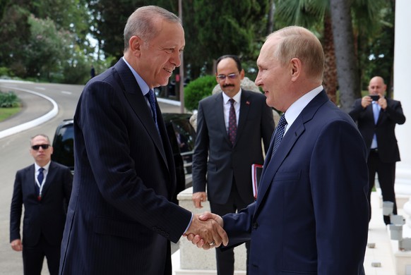 Russian President Vladimir Putin, right, greets Turkish President Recep Tayyip Erdogan upon his arrival at the Rus sanatorium in the Black Sea resort of Sochi, Russia, Friday, Aug. 5, 2022. Erdogan&#0 ...
