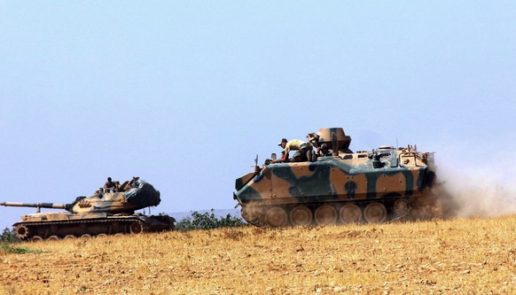 A Turkish army tank and an armored vehicle are stationed near the border with Syria, in Karkamis, Turkey, Tuesday, Aug. 23, 2016. Turkish media reports say Turkish artillery on Tuesday launched new st ...