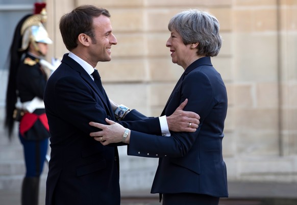 epa07494366 French President Emmanuel Macron (L) greets British Prime Minister Theresa May (R) as she arrives for a meeting at the Elysee Palace in Paris, France, 09 April 2019. British Prime Minister ...