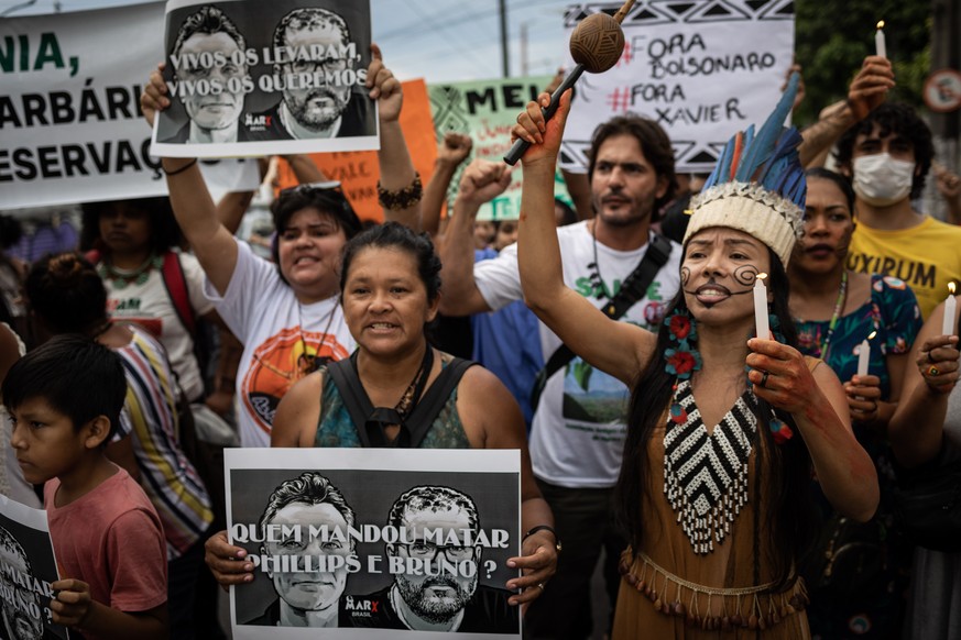 epa10015256 Demonstrators light candles in front of the headquarters of the National Indian Foundation (FUNAI), during a protest against the disappearance of indigenous guide Bruno Pereira and British ...