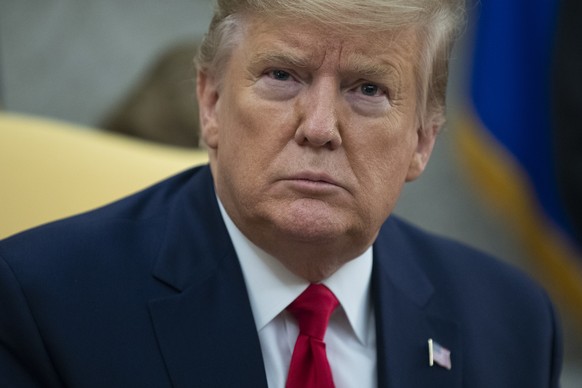President Donald Trump listens to a question during a meeting with Guatemalan President Jimmy Morales in the Oval Office of the White House, Tuesday, Dec. 17, 2019, in Washington. (AP Photo/ Evan Vucc ...