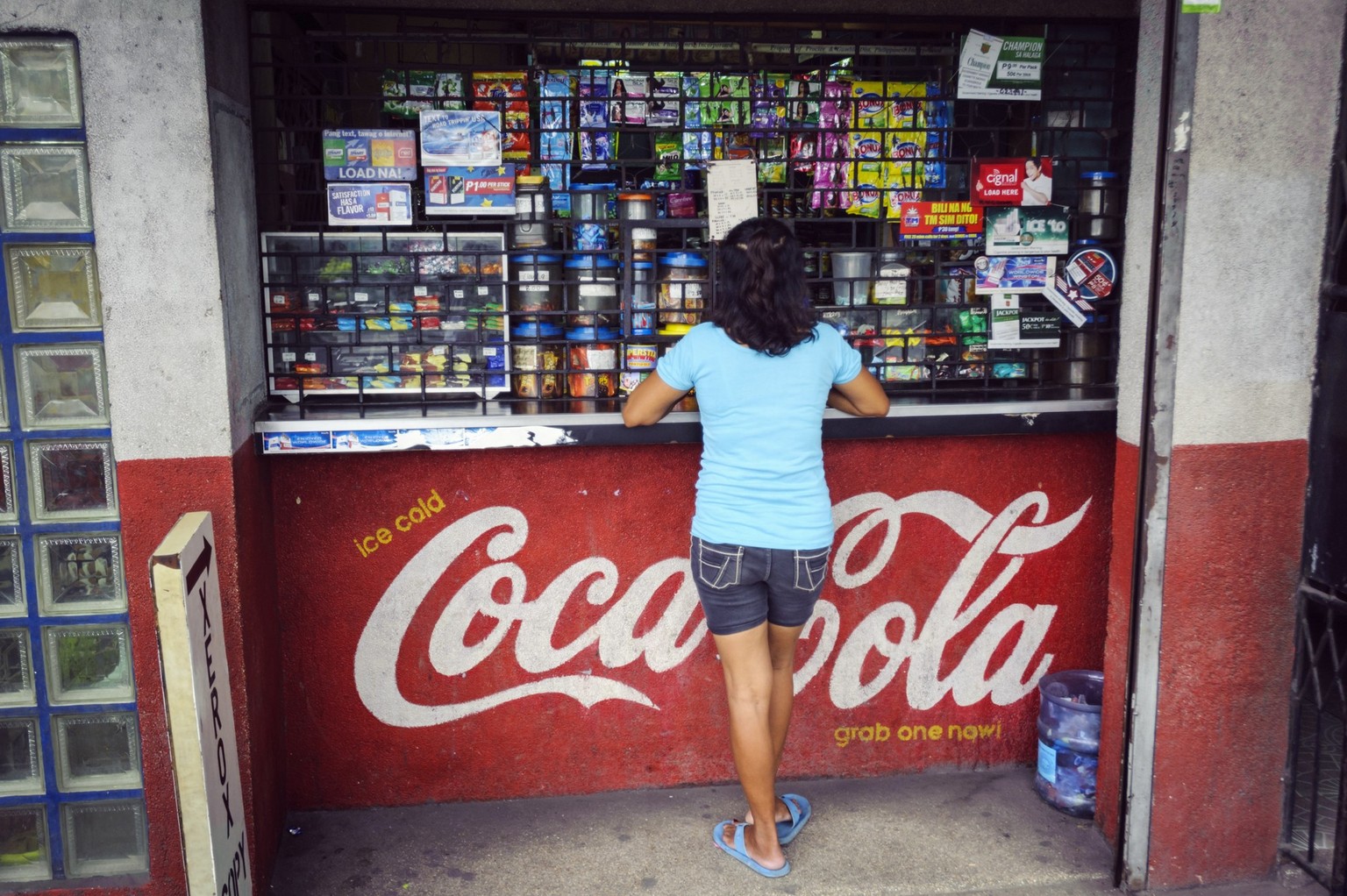 Cebu, Philippines - January 7, 2013: A woman at a conveniece store, locally known as a sari-sari, on Bacalso Avenue in Cebu City, Philippines, Asia.
