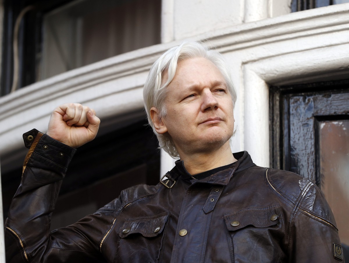 Julian Assange greets supporters outside the Ecuadorian embassy in London, Friday May 19, 2017. Sweden's top prosecutor says she is dropping an investigation into a rape claim against WikiLeaks f ...