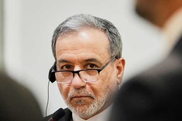 Iranian Foreign Minister Abbas Araghchi listens to his Iraqi counterpart Fouad Hussein during a news conference after a meeting at the foreign ministry in Baghdad, Iraq, Sunday, June 28, 2026. (AP Pho ...