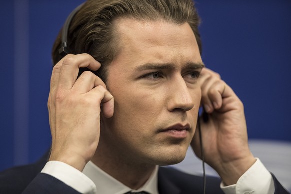 Austrian Chancellor Sebastian Kurz adjusts his earphones during a joint press conference held at the European Parliament, in Strasbourg, eastern France, Tuesday, July 3, 2018. Austria takes over the E ...