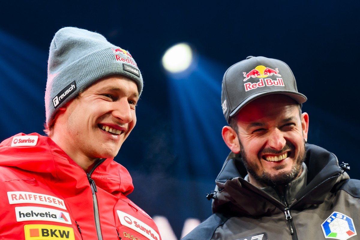 The winner Marco Odermatt of Switzerland reacts with third placed Dominik Paris of Italy during the Awards ceremony of the men's downhill race at the Alpine Skiing FIS Ski World Cup in Wengen, Sw ...