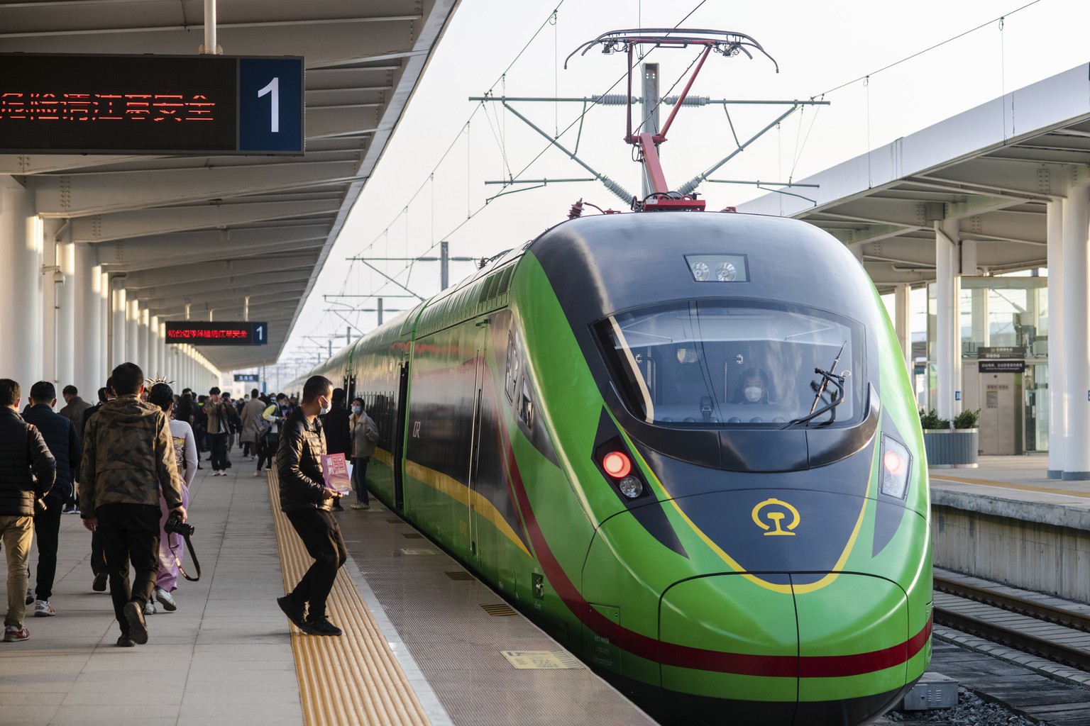 In this photo released by Xinhua News Agency, an electric multiple unit (EMU) train of the China-Laos Railway arrives at Yuxi Railway Station in Yuxi in southwestern China&#039;s Yunnan Province, Frid ...