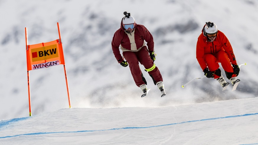 epa11067710 Former Swiss skiers Beat Feuz (L) and Marc Berthod speed down the slope for the Swiss TV SRF during the men&#039;s downhill training race of the FIS Alpine Skiing World Cup in Wengen, Swit ...