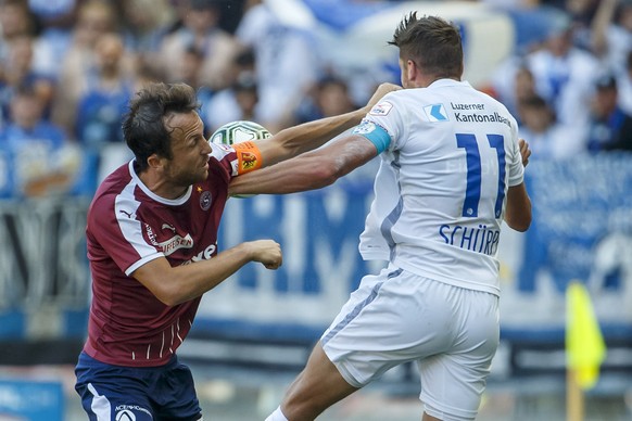 Servette&#039;s defender Anthony Sauthier, left, fights for the ball with Luzern&#039;s midfielder Pascal Schuerpf, right, during the Super League soccer match of Swiss Championship between Servette F ...