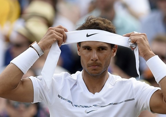 epa06079628 Rafael Nadal of Spain in between games against Gilles Muller of Luxembourg during their fourth round match for the Wimbledon Championships at the All England Lawn Tennis Club, in London, B ...