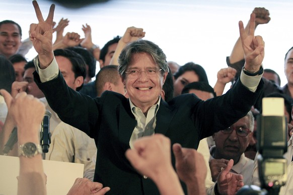 epa05804712 Ecuadorian presidential candidate Guillermo Lasso (C) poses prior delivering a speech to supporters in Guayaquil, Ecuador, 19 February 2017. Preliminary results of Ecuador&#039;s elections ...