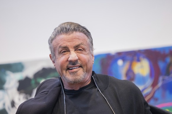 Sylvester Stallone, actor and painter, sits in the exhibition &quot;Sylvester Stallone - 75th Birthday Retrospective&quot; at the Osthaus Museum in Hagen, Germany, Dec. 3, 2021. The Hollywood star Syl ...