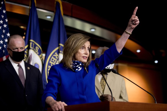 House Speaker Nancy Pelosi of Calif., accompanied by Rep. Dan Kildee, D-Mich., left, and Rep. Danny Davis, D-Ill., right, speaks at a news conference on Capitol Hill in Washington, Friday, July 24, 20 ...