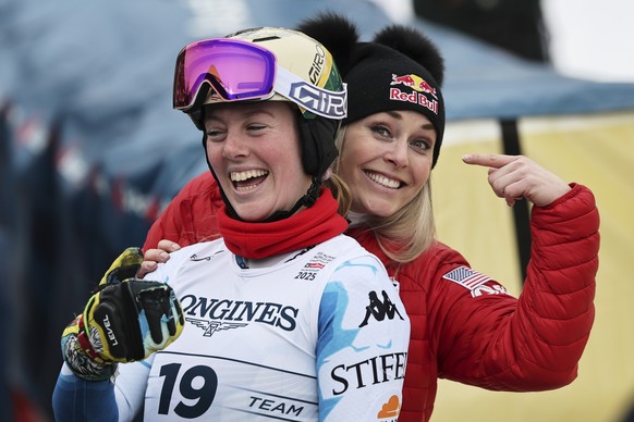 United States' A.J. Hurt and United States' Lindsey Vonn, right, smile at the finish area of a slalom run of a women's team combined event, at the Alpine Ski World Championships, in Saa ...